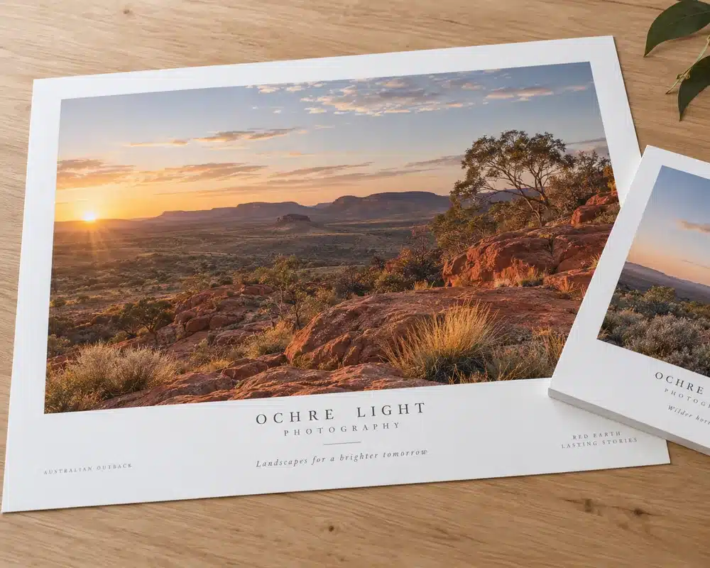 Large printed artboard sheets on a timber desk